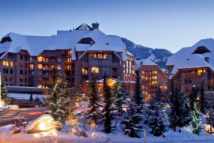 The exterior of the Four Seasons hotel in Whistler at sunset in winter