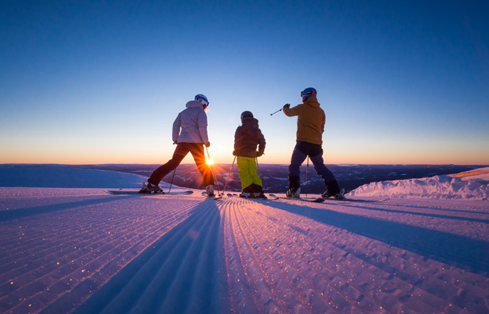 Skiers in Norway and sunset