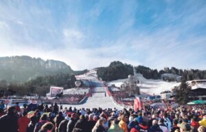 A crowd of people watching the Alpine racing in Kitzbuhel