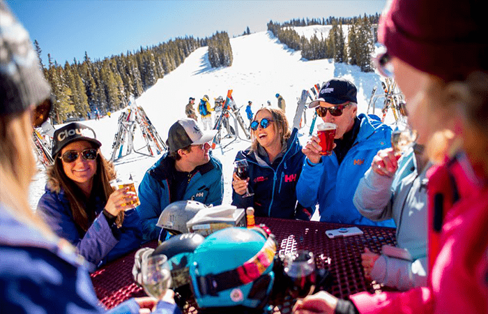 Mixed group of skiers enjoying après in the ski resort